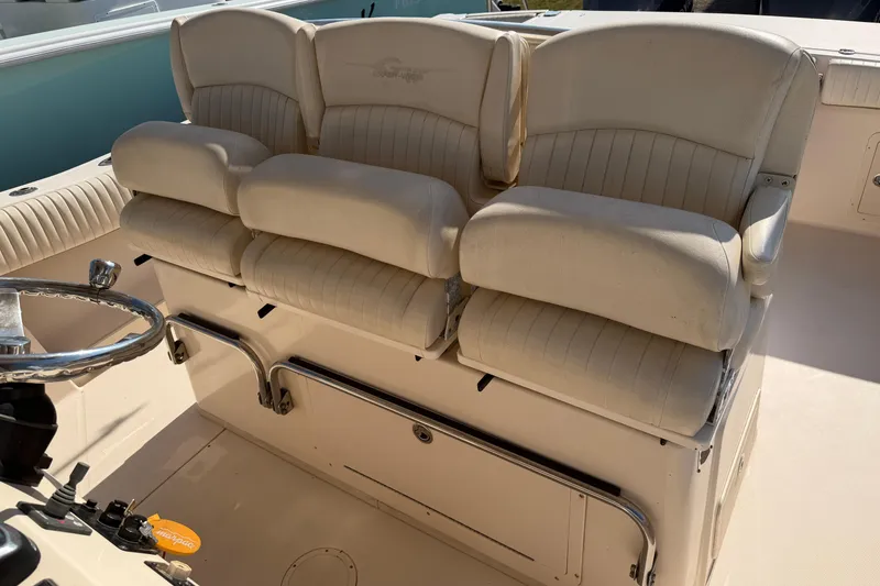 Slide: The Image of 2010 Grady-White Canyon 336 boat seating with cushioned helm chairs. - 62
