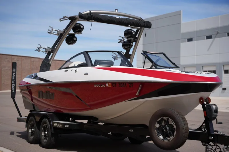 Slide: The Image of 2018 Malibu Wakesetter 21 VLX boat on trailer, red and white design. - 6