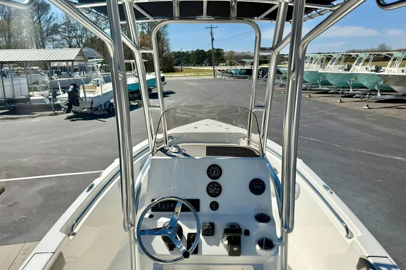 Slide: The Image of 2026 Key West 189 FS boat interior with steering console and gauges in a marina setting. - 22