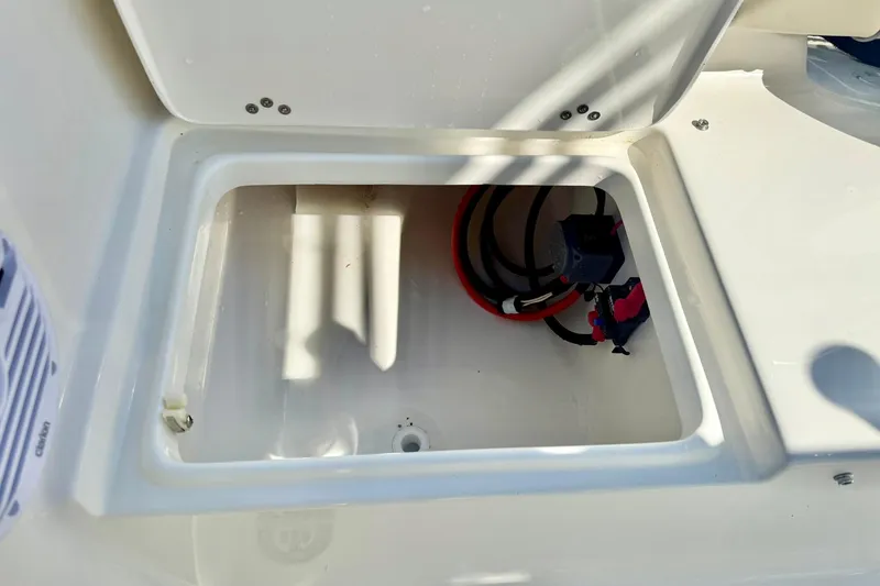 Slide: The Image of Open storage compartment in 2026 Key West 189 FS boat, showing wiring and connections. - 25