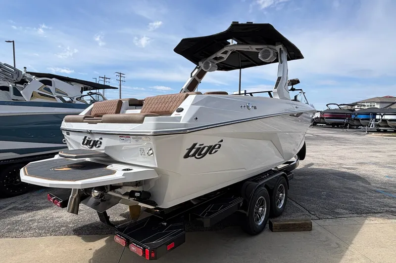 Slide: The Image of 2026 Tigé Z3 boat on trailer, parked outdoors under a clear sky. - 11