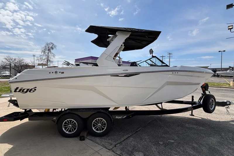 Slide: The Image of 2026 Tigé Z3 boat on trailer under clear blue sky. - 12