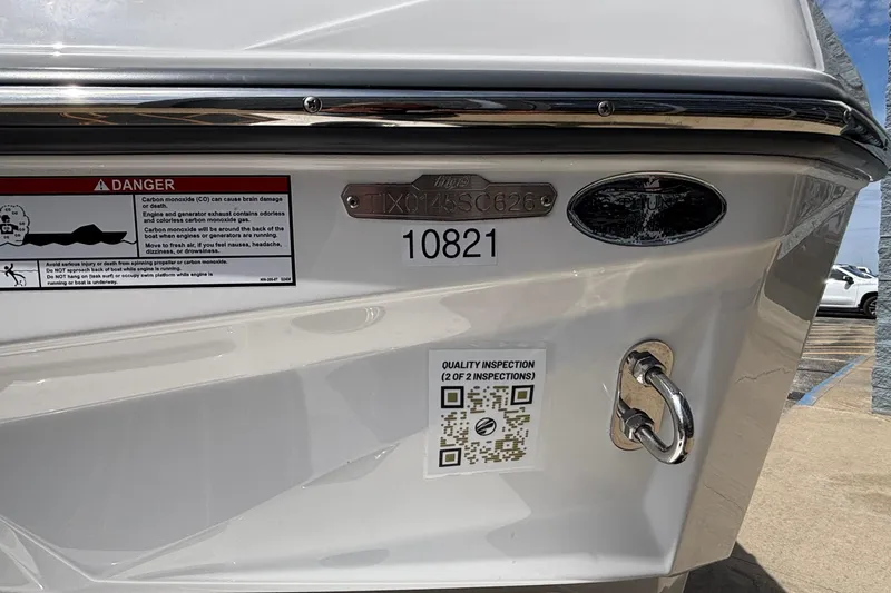 Slide: The Image of 2026 Tigé Z3 boat stern with inspection sticker and safety warning label. - 14