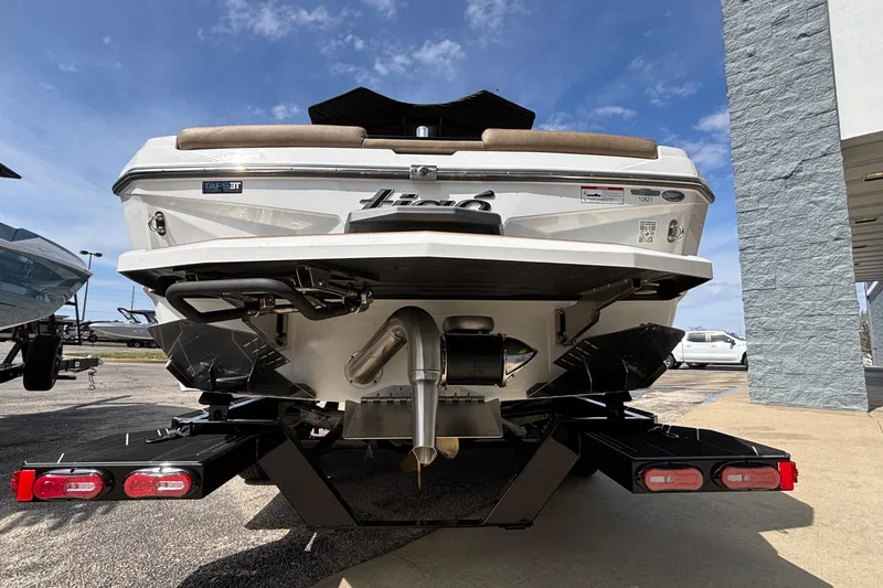 Slide: The Image of 2026 Tigé Z3 boat rear view, showcasing sleek design and advanced features under a clear sky. - 15