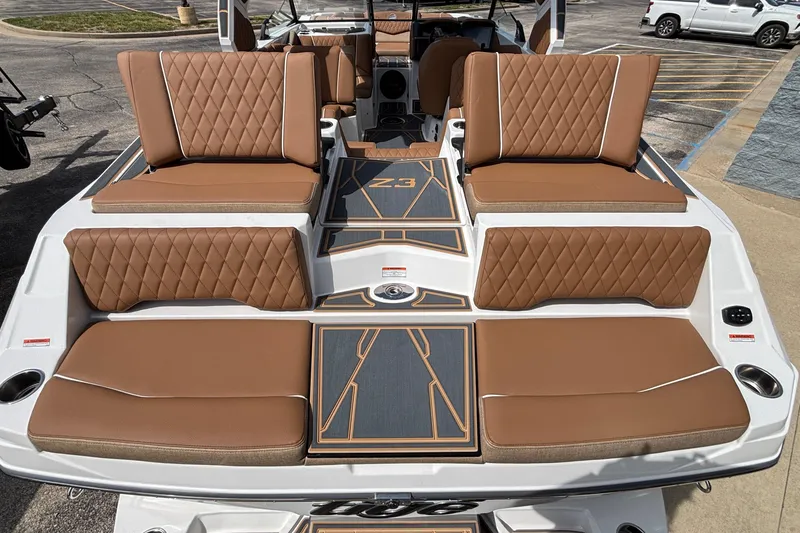 Slide: The Image of 2026 Tigé Z3 boat interior with luxurious brown quilted seating and stylish deck design. - 19