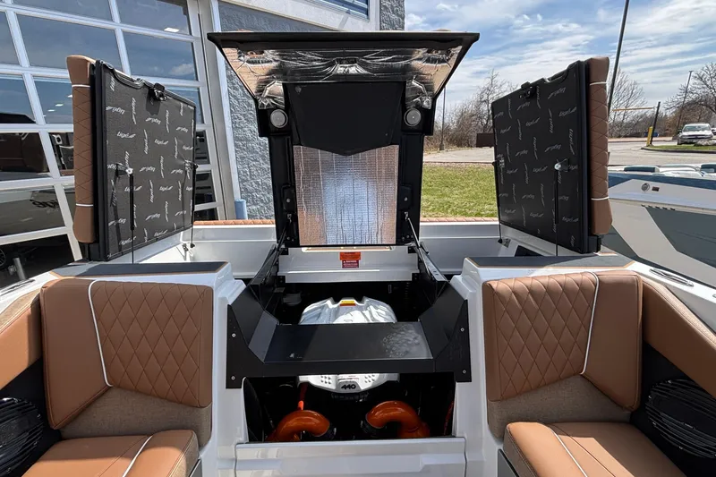 Slide: The Image of 2026 Tigé Z3 boat interior with open engine compartment, featuring brown quilted seats. - 27