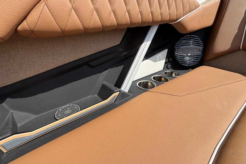 Slide: The Image of 2026 Tigé Z3 interior with brown leather seats, cup holders, and speaker system. - 42
