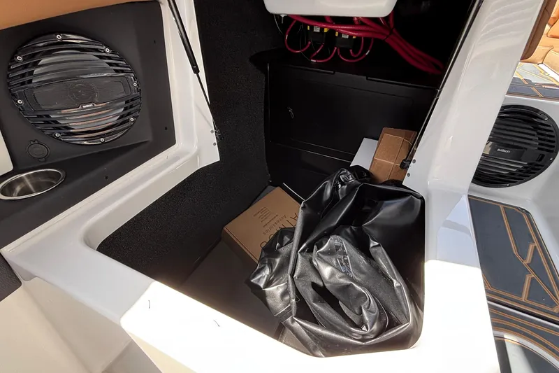 Slide: The Image of Interior storage compartment of 2026 Tigé Z3 boat with speaker and wiring. - 51