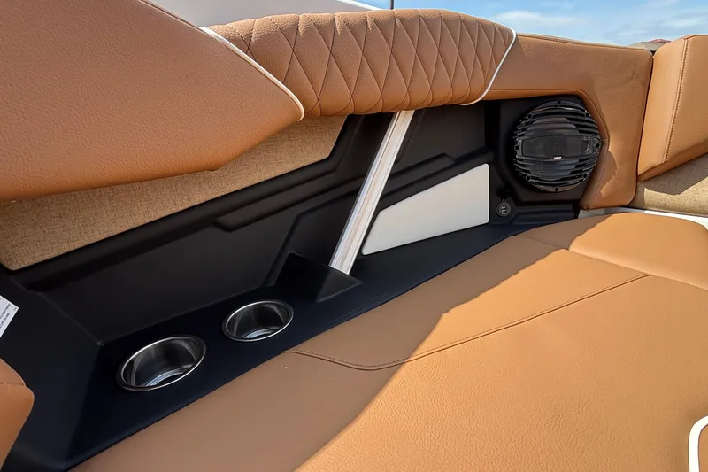 Slide: The Image of 2026 Tigé Z3 boat interior with tan upholstery, cup holders, and speaker system. - 62