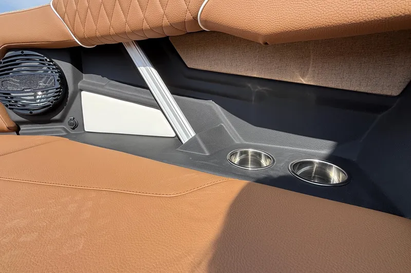Slide: The Image of 2026 Tigé Z3 boat interior with brown upholstery, speaker, and cup holders. - 63