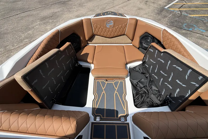 Slide: The Image of 2026 Tigé Z3 boat interior with brown quilted seating and storage compartments. - 65