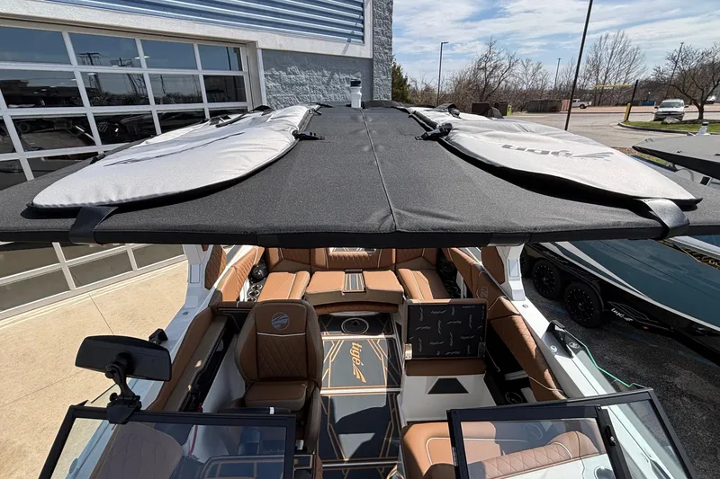 Slide: The Image of 2026 Tigé Z3 boat with covered seating and surfboards on top. - 67