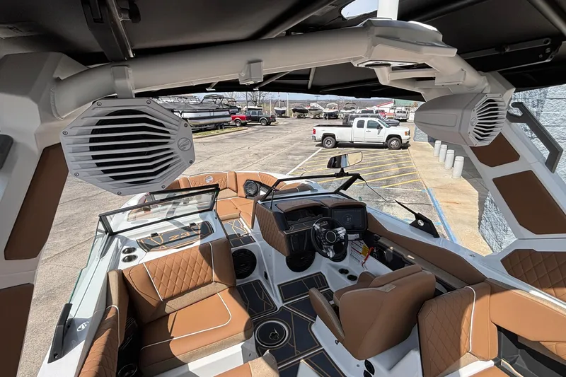 Slide: The Image of 2026 Tigé Z3 boat interior with brown seating and advanced dashboard features. - 70