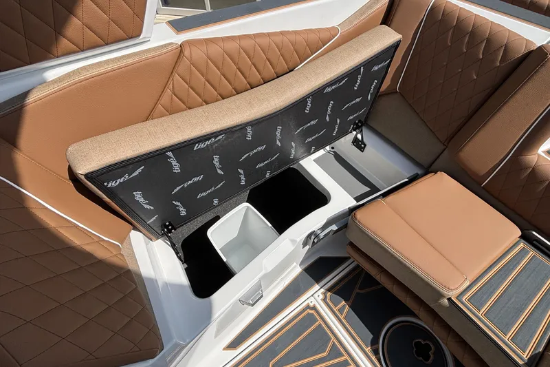 Slide: The Image of 2026 Tigé Z3 boat interior with tan quilted seats and open storage compartment. - 71