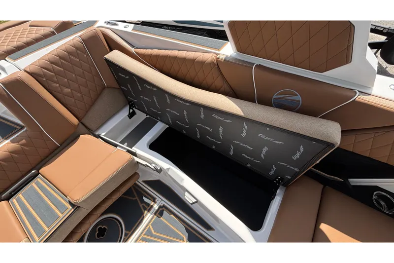 Slide: The Image of 2026 Tigé Z3 boat interior with luxurious brown quilted seating and storage compartment. - 72