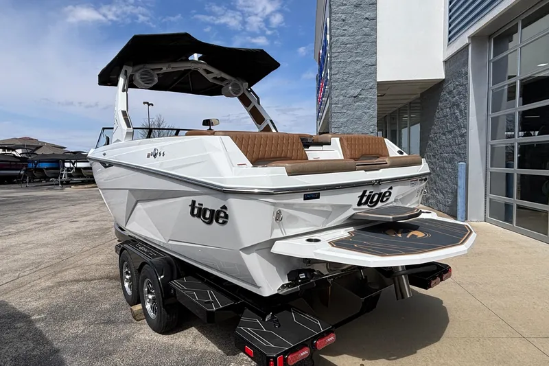 Slide: The Image of 2026 Tigé Z3 boat on trailer, white exterior, brown seating, parked outside dealership. - 9