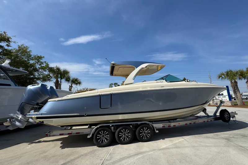 Slide: The Image of 2026 Chris-Craft Launch 35 GT boat on trailer under clear blue sky. - 10