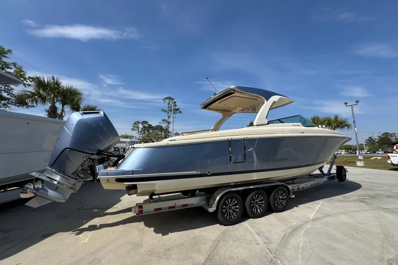Slide: The Image of 2026 Chris-Craft Launch 35 GT boat on trailer, parked outdoors under clear sky. - 11