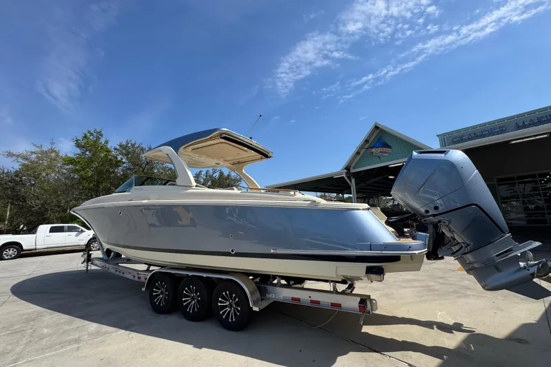 Slide: The Image of 2026 Chris-Craft Launch 35 GT boat on trailer under clear blue sky. - 17