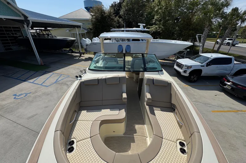 Slide: The Image of 2026 Chris-Craft Launch 35 GT boat with luxurious seating, parked outdoors. - 22