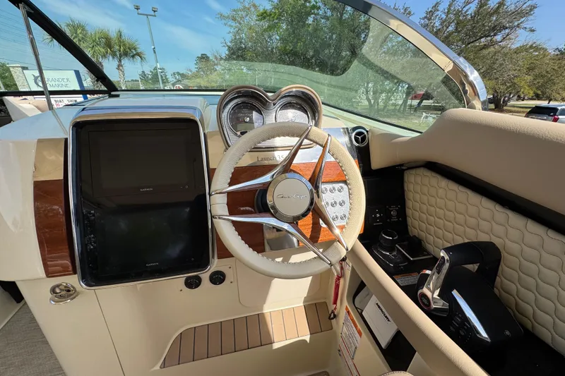 Slide: The Image of 2026 Chris-Craft Launch 35 GT dashboard with steering wheel and navigation display. - 27
