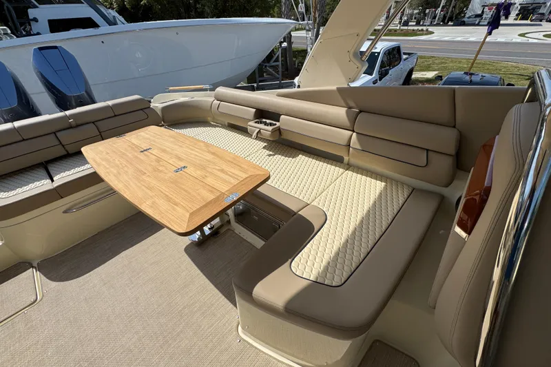Slide: The Image of Luxurious seating area on 2026 Chris-Craft Launch 35 GT boat with wooden table. - 35