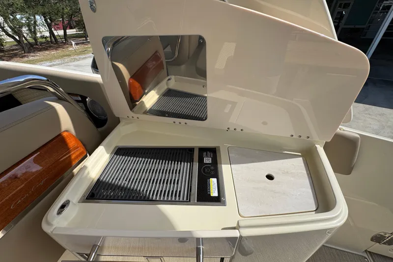 Slide: The Image of 2026 Chris-Craft Launch 35 GT boat interior with grill and sink setup. - 38