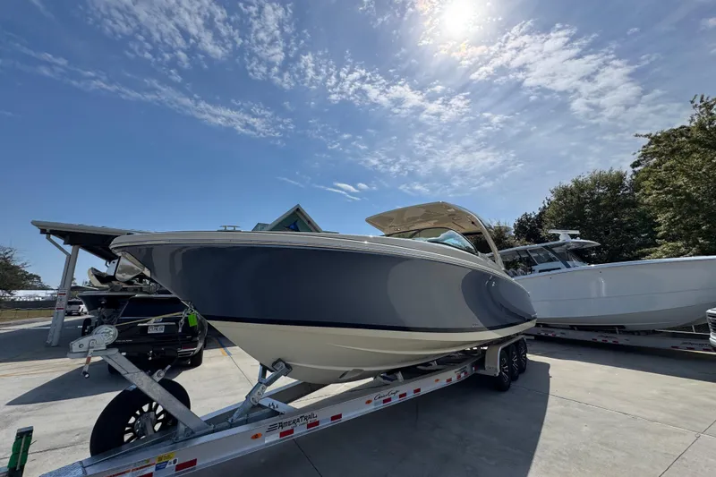 Slide: The Image of 2026 Chris-Craft Launch 35 GT boat on trailer under sunny sky. - 4