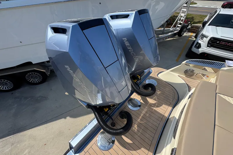 Slide: The Image of Twin Mercury outboard engines on a 2026 Chris-Craft Launch 35 GT boat, docked near a trailer. - 46