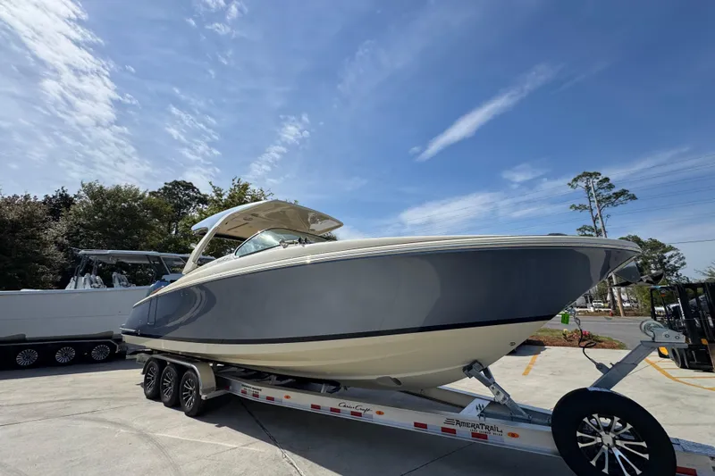 Slide: The Image of 2026 Chris-Craft Launch 35 GT boat on trailer under clear blue sky. - 8