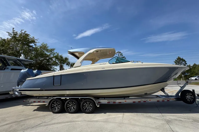 Slide: The Image of 2026 Chris-Craft Launch 35 GT boat on trailer under clear blue sky. - 9
