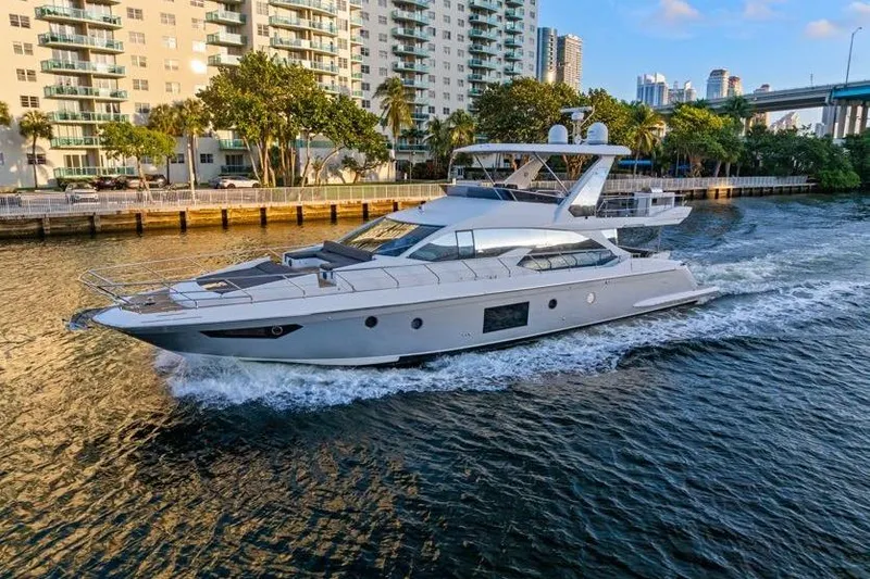 The Image of Luxurious 2017 Azimut 66 yacht cruising near waterfront buildings. - 0