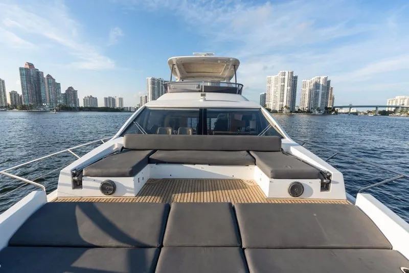 Slide: The Image of Luxurious 2017 Azimut 66 yacht on water with city skyline backdrop. - 14