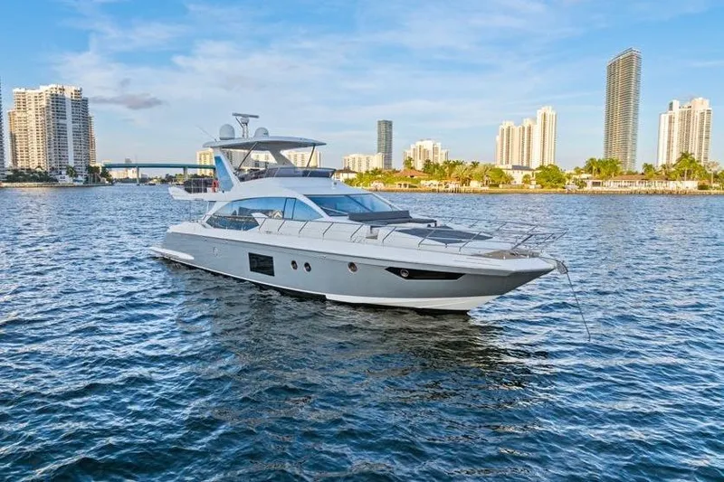 Slide: The Image of Luxurious 2017 Azimut 66 yacht cruising near city skyline on a sunny day. - 2