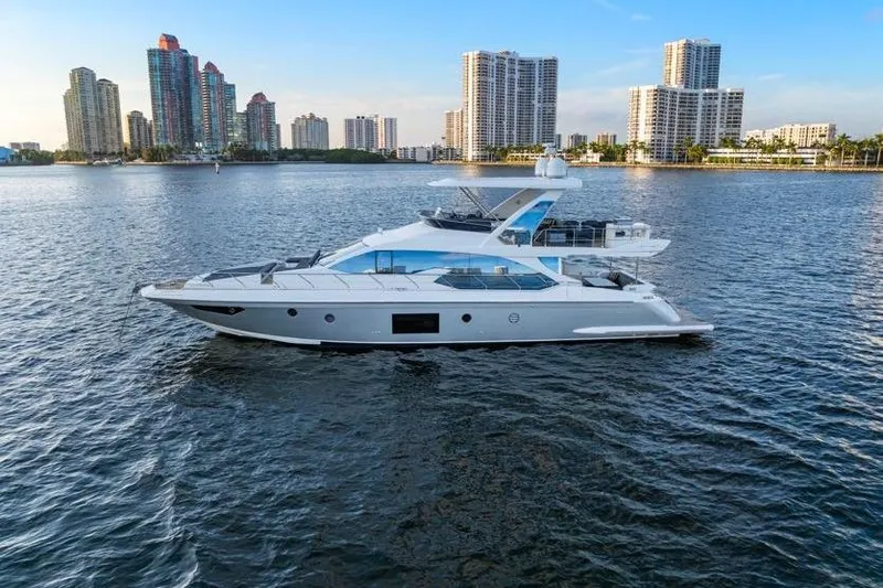 Slide: The Image of 2017 Azimut 66 yacht cruising near city skyline on calm waters. - 3