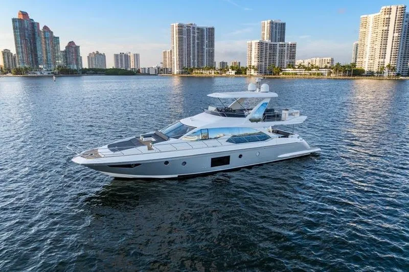 Slide: The Image of 2017 Azimut 66 yacht cruising near city skyline on calm waters. - 4