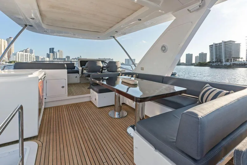 Slide: The Image of Luxurious 2017 Azimut 66 yacht deck with seating, table, and city skyline view. - 7