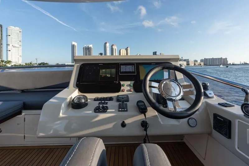 Slide: The Image of Cockpit view of 2017 Azimut 66 yacht with city skyline in background. - 8
