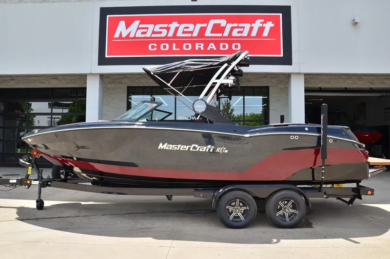 The Image of 2023 MasterCraft NXT23 boat on trailer at dealership in Colorado. - 1
