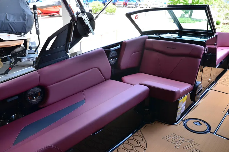 Slide: The Image of 2023 MasterCraft NXT23 boat interior with maroon seating and sleek design. - 11