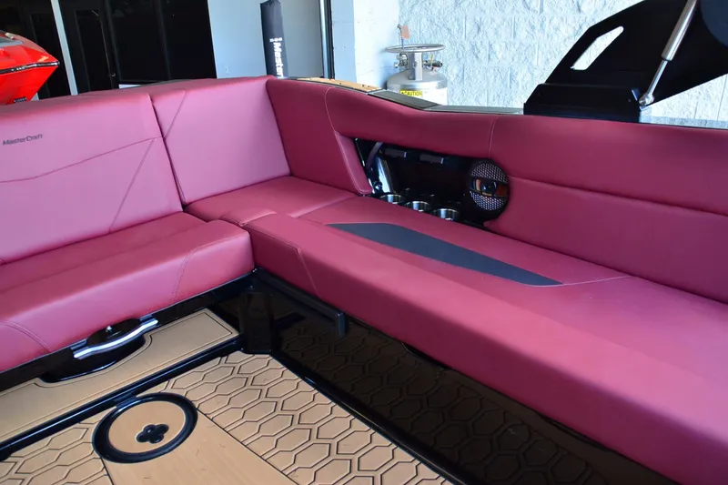 Slide: The Image of 2023 MasterCraft NXT23 interior with red seating and modern design elements. - 13