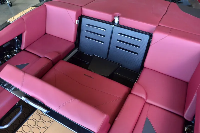 Slide: The Image of 2023 MasterCraft NXT23 boat interior with red upholstery and storage compartments. - 14