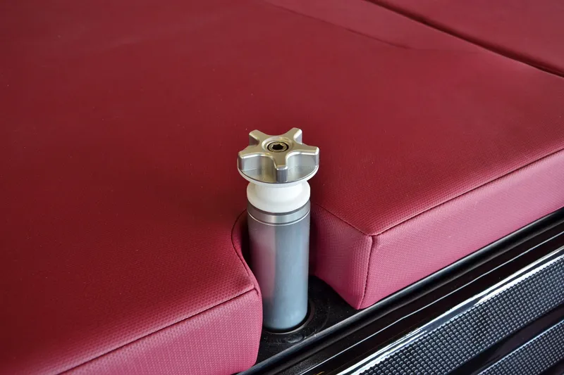 Slide: The Image of 2023 MasterCraft NXT23 boat seat with red upholstery and metal support. - 16