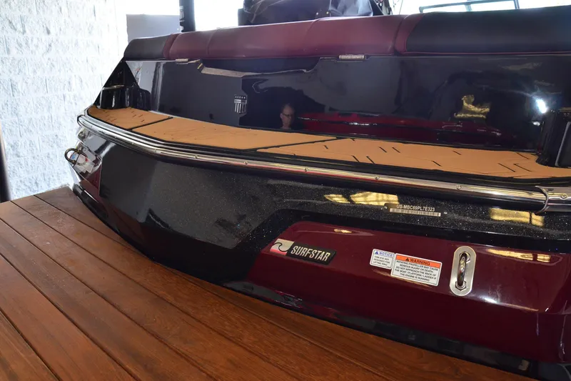 Slide: The Image of 2023 MasterCraft NXT23 boat rear view with SurfStar feature, displayed indoors. - 18