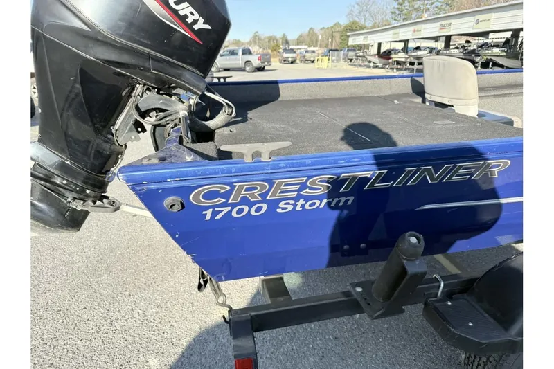 Slide: The Image of 2020 Crestliner 1700 Storm boat with Mercury engine, parked outdoors. - 12