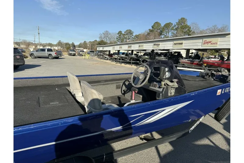 Slide: The Image of 2020 Crestliner 1700 boat, blue exterior, parked outdoors at a dealership. - 8
