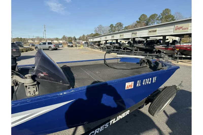 Slide: The Image of 2020 Crestliner 1700 boat in parking lot, blue exterior, registration visible. - 9