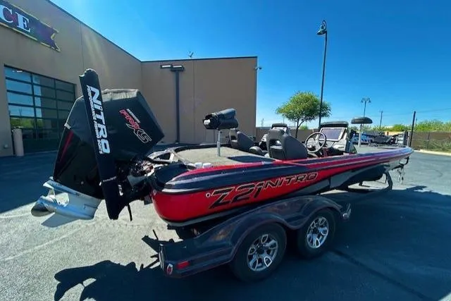 Slide: The Image of 2019 Nitro Z21 Elite boat on trailer, parked outdoors under clear blue sky. - 3