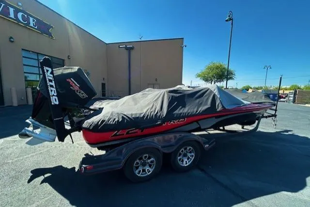 Slide: The Image of 2019 Nitro Z21 Elite boat covered on a trailer in a parking lot. - 5