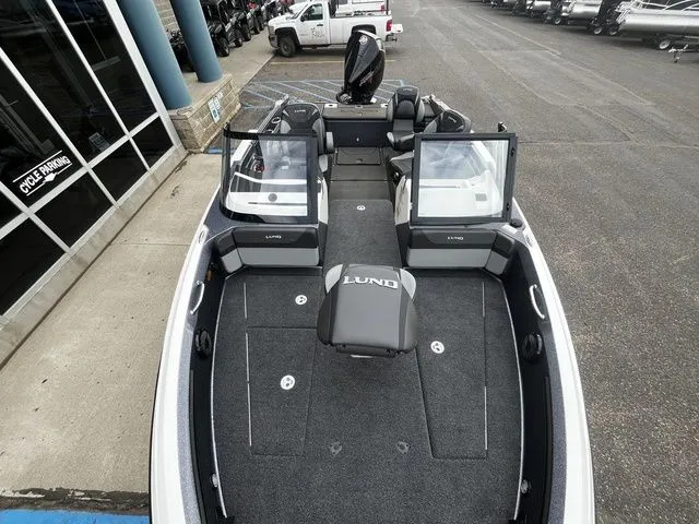 Slide: The Image of Lund 2026 202 PRO-V GL Sport boat displayed in parking lot. - 28